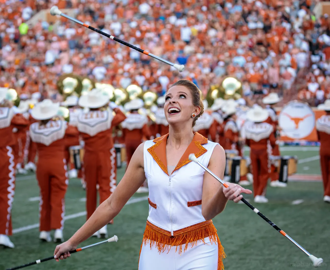 Collegiate feature twirler performing in a stadium